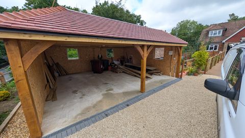 Double-bay oak carport with a tiled roof