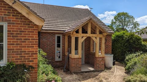 Oak-framed porch entrance on a brick period home