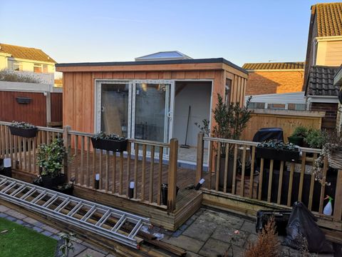 Garden room with sliding doors and roof lantern photographed at dusk